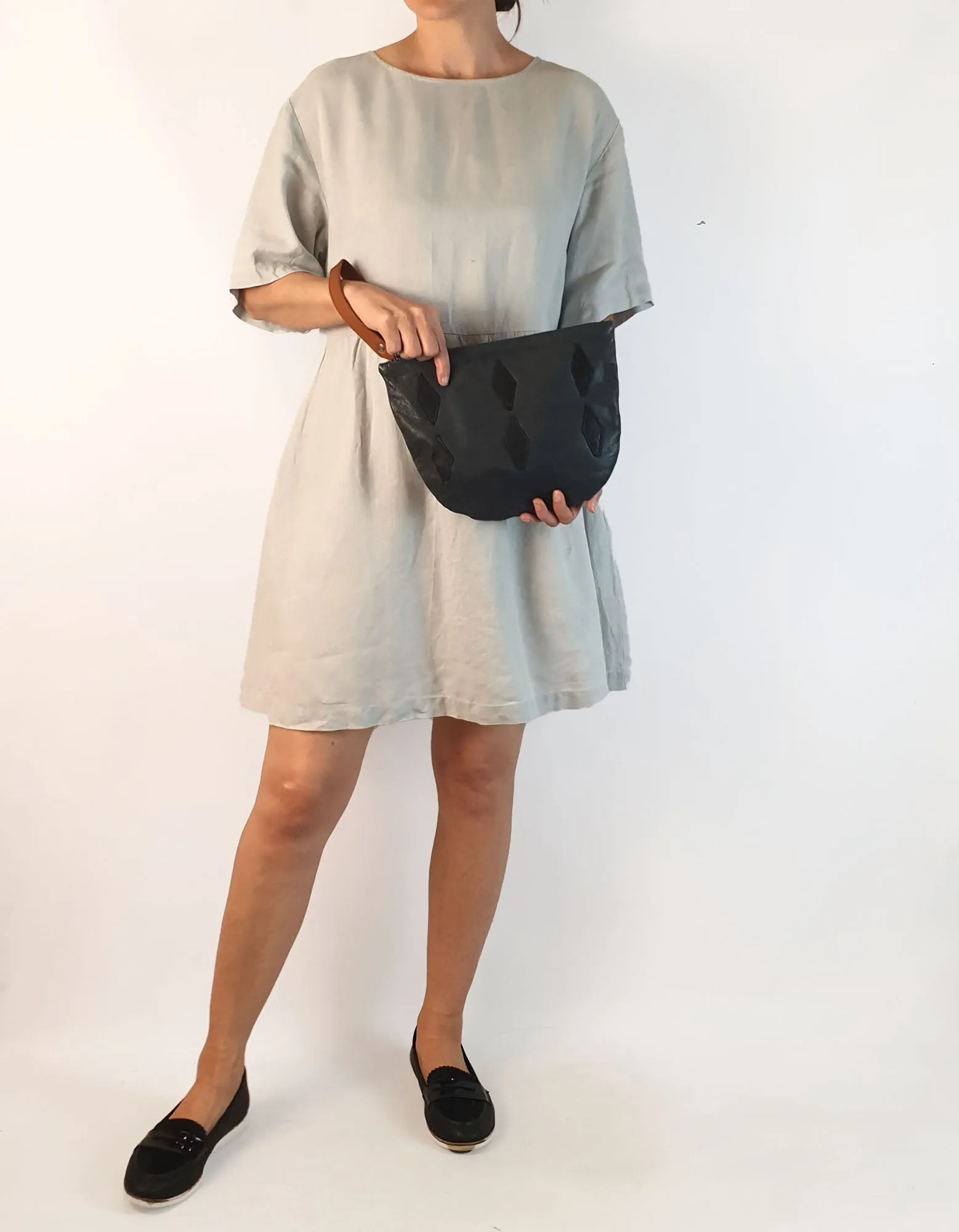 Nancybird soft leather navy clutch with brown wrist strap