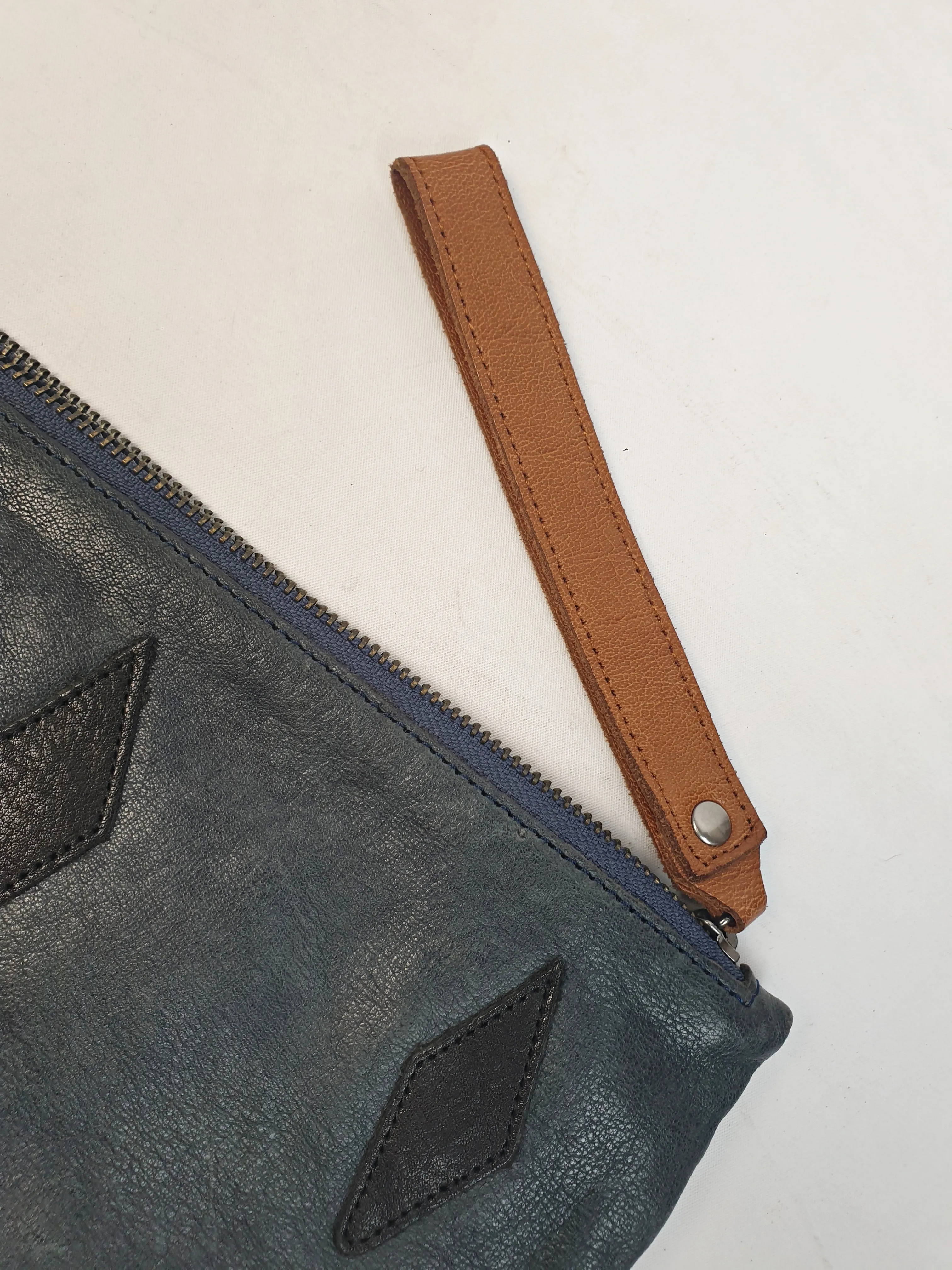 Nancybird soft leather navy clutch with brown wrist strap